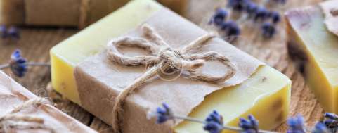 Lavender soap and salt on rustic wooden board. Spa concept